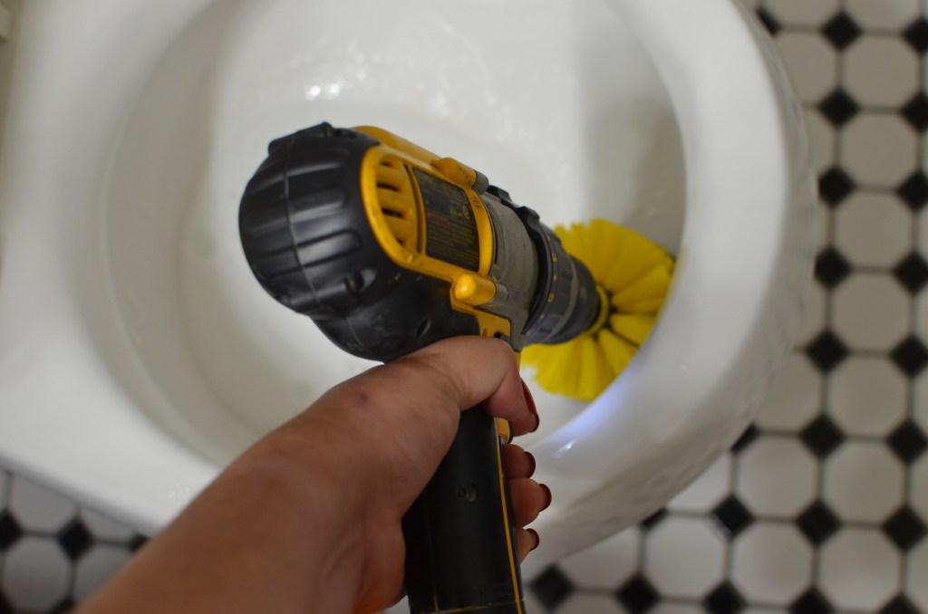 scrubbing toilet bowl with drillbrush