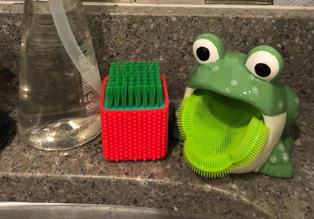 frog with silicone scrub brush on sink