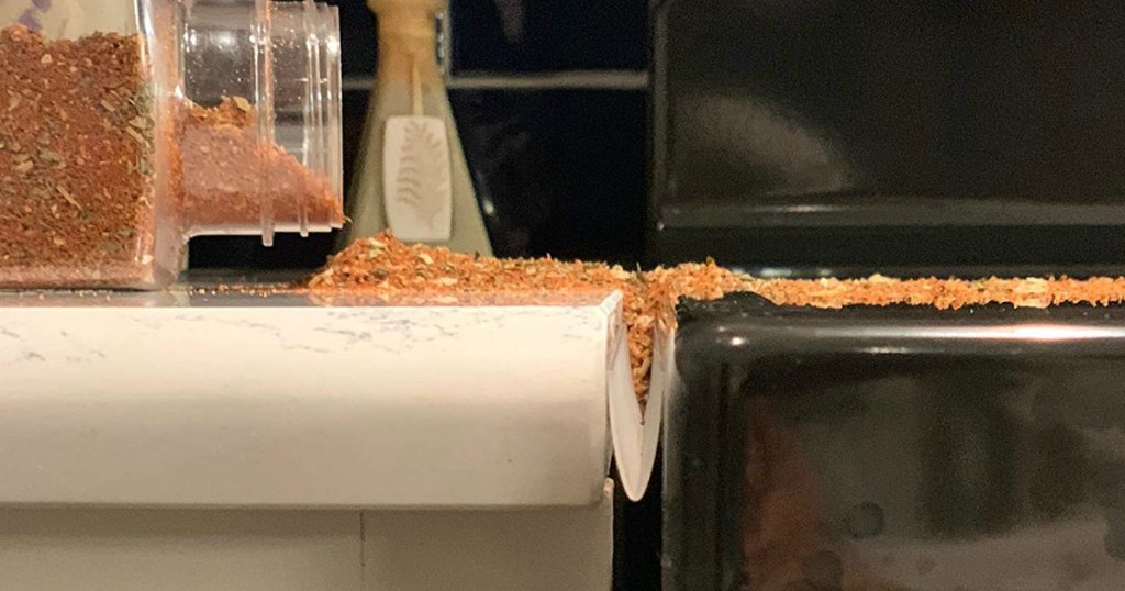 spice spilling on counter top by oven range