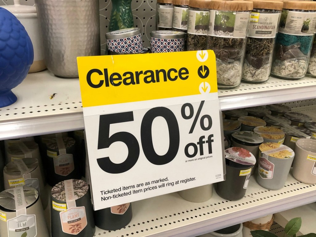 yellow and white clearance sign on store shelf