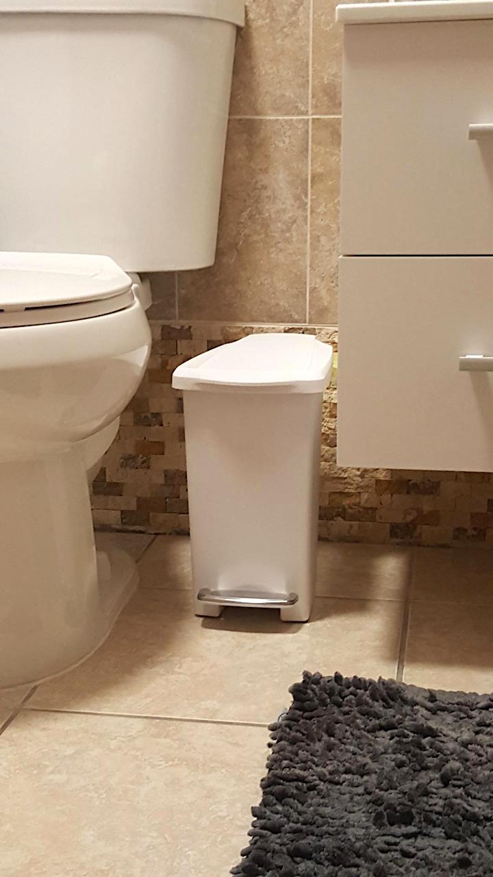 super slim trash can inbetween toilet and bathroom counter 