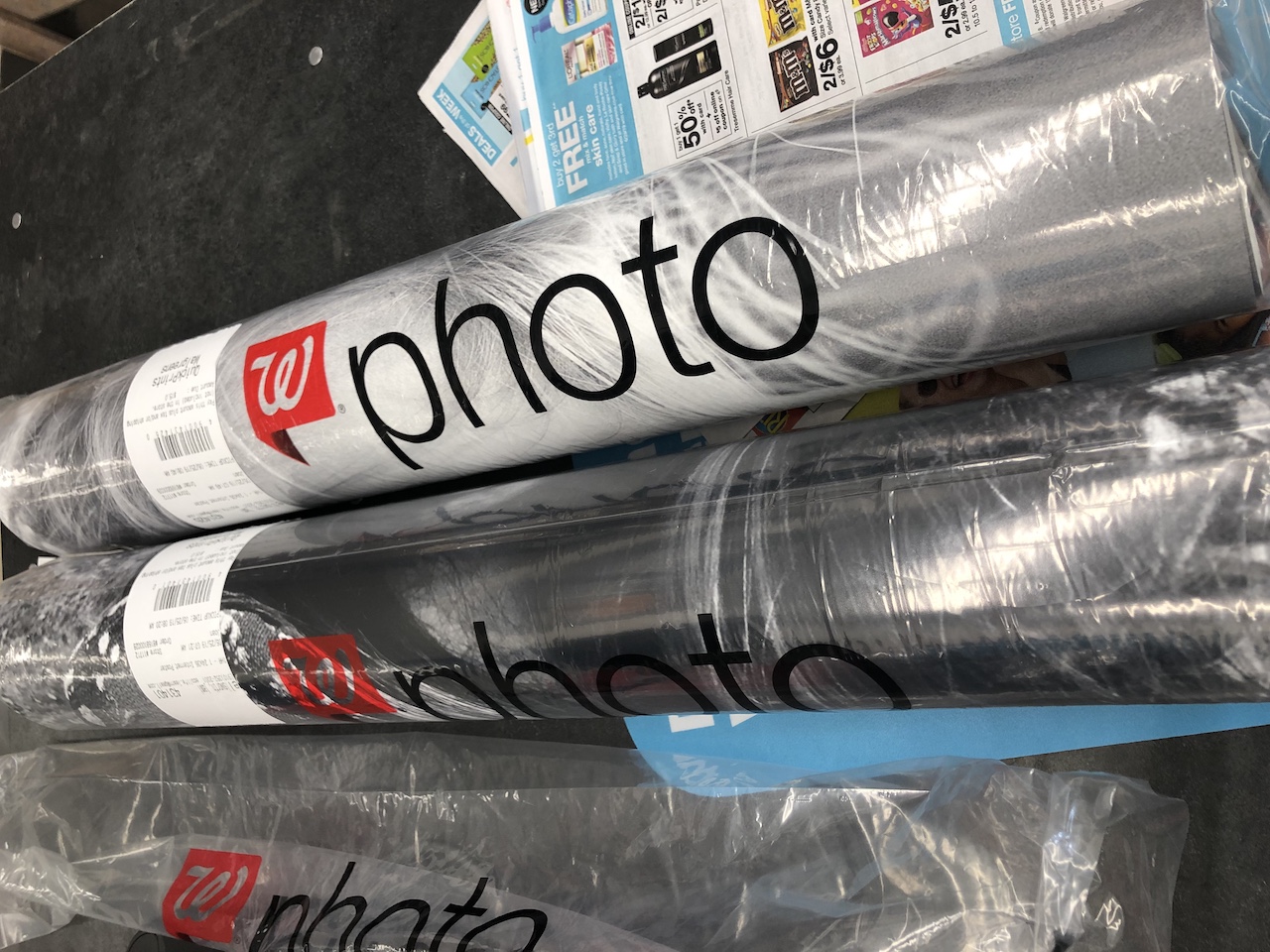 Walgreens poster prints rolled up on counter 