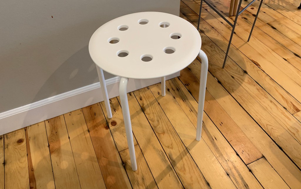 white ikea stool on wood floor 