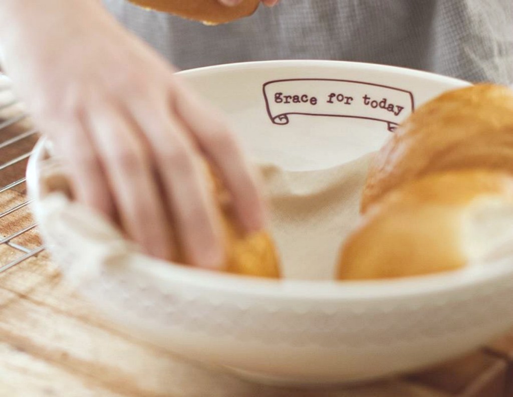 hand getting bread out of Serving Bowl
