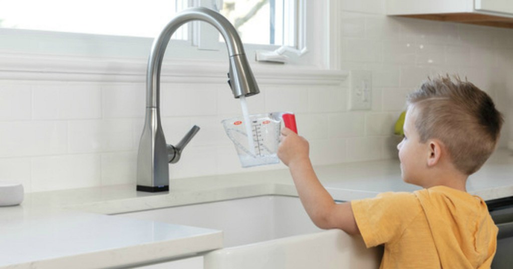 boy using sink with Delta VoiceIQ Technology