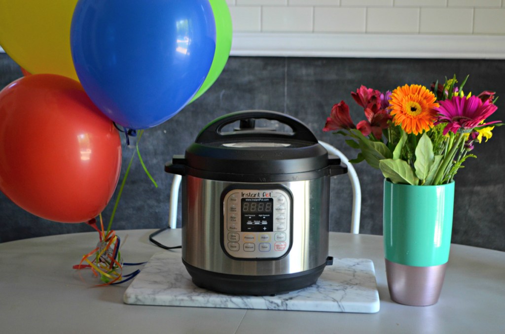 Instant pot next to balloons and flowers
