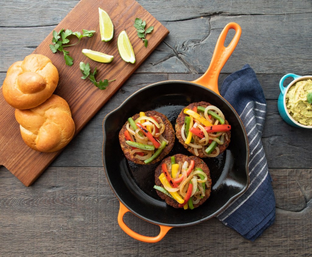 Le Creuset cast iron skillet on counter with food 