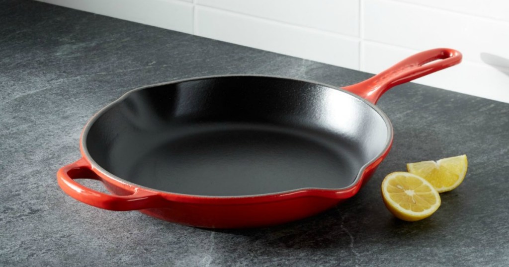 Le Creuset cast iron skillet on counter with lemon slice