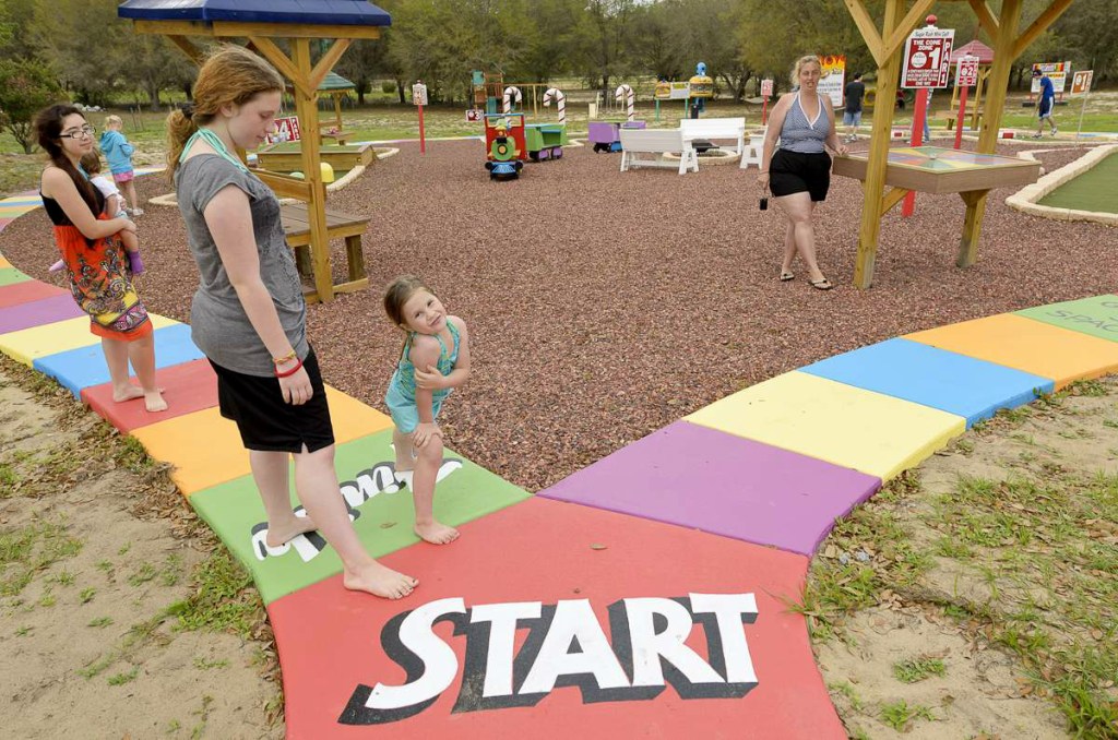 girl and lady standing on huge board game