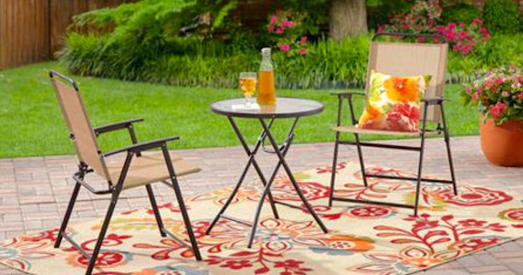 bistro set on patio with outdoor rug 