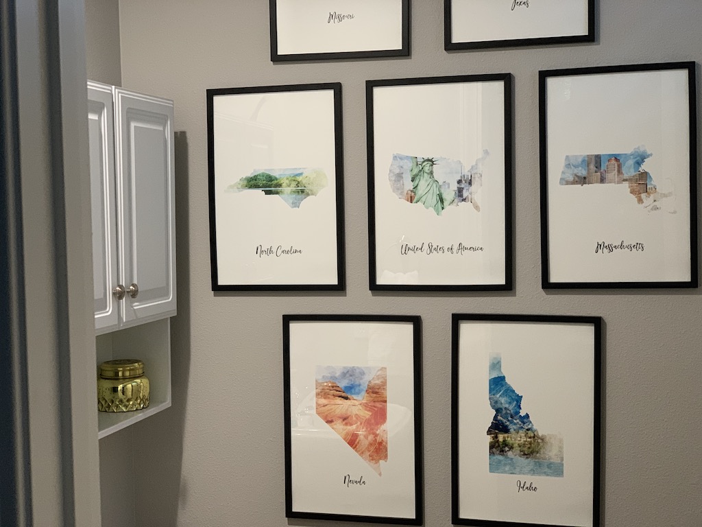 watercolor map prints gallery wall in bathroom 