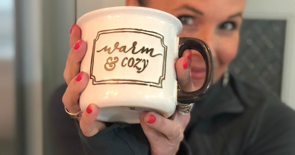 woman living Hygge lifestyle holding warm and cozy mug 