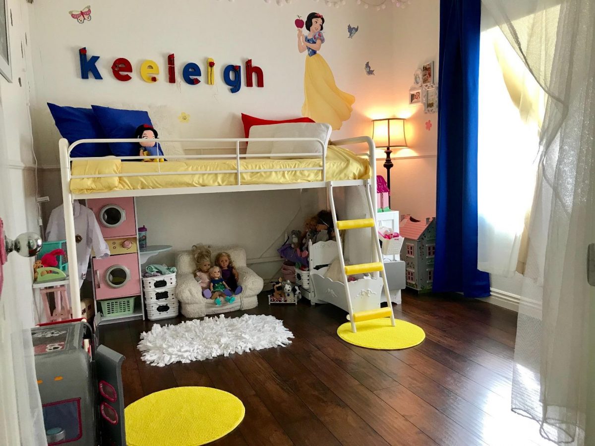 Adorable kids loft bed in white with toys stored under the bed