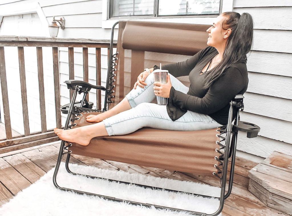 women lounging outside on deck with drink 