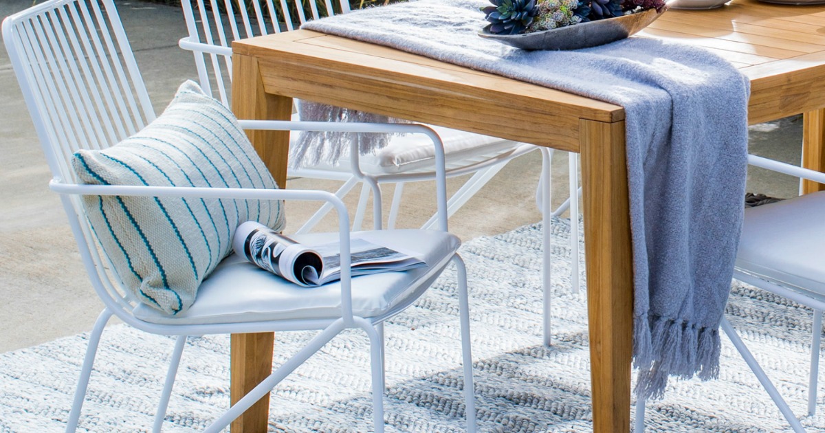 modern patio chairs next to outdoor table 