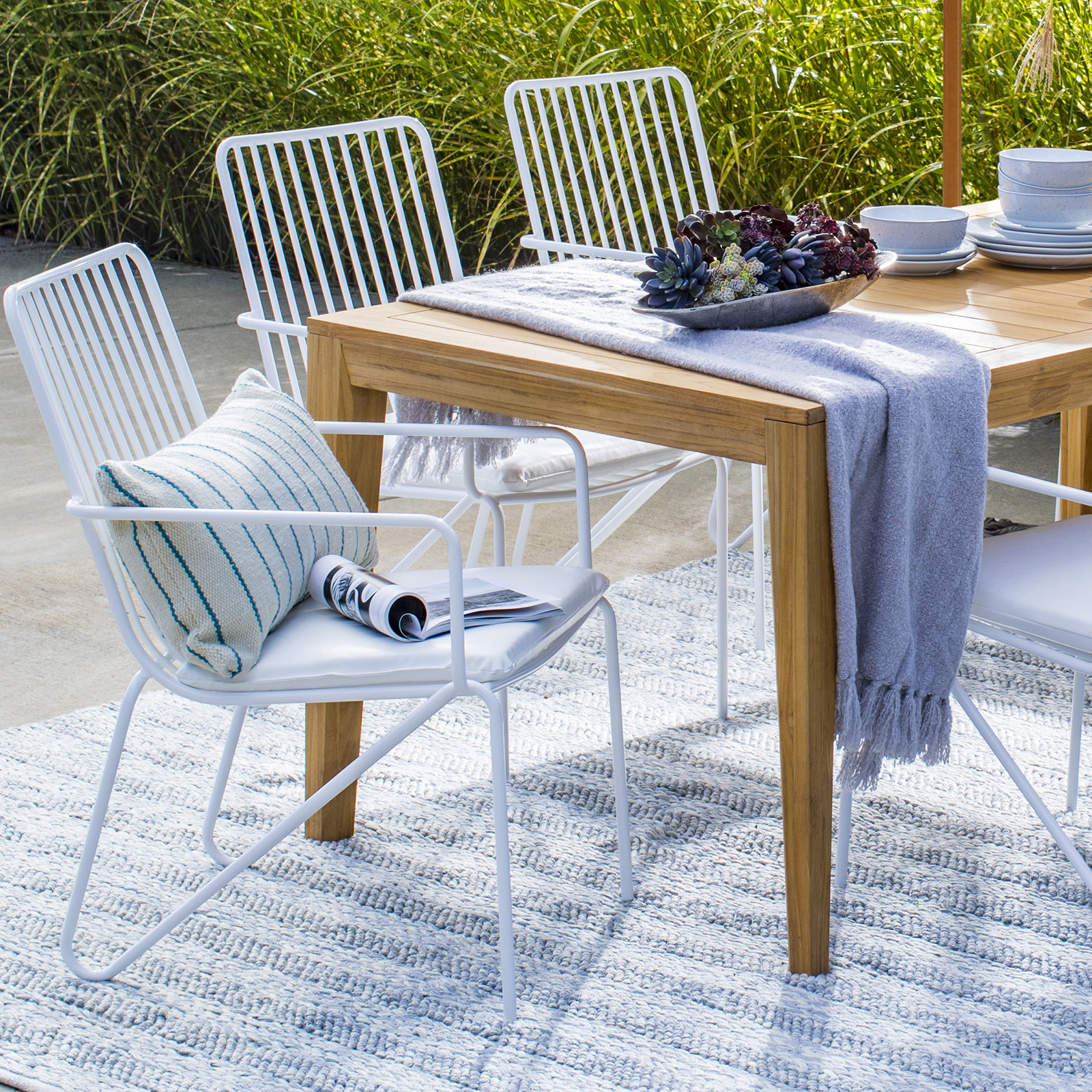 modern white patio chairs around outdoor table 