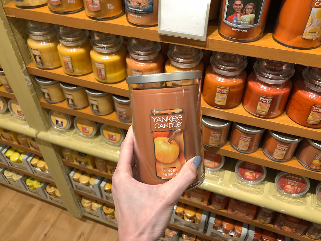 holding Yankee Candle spiced pumpkin scent