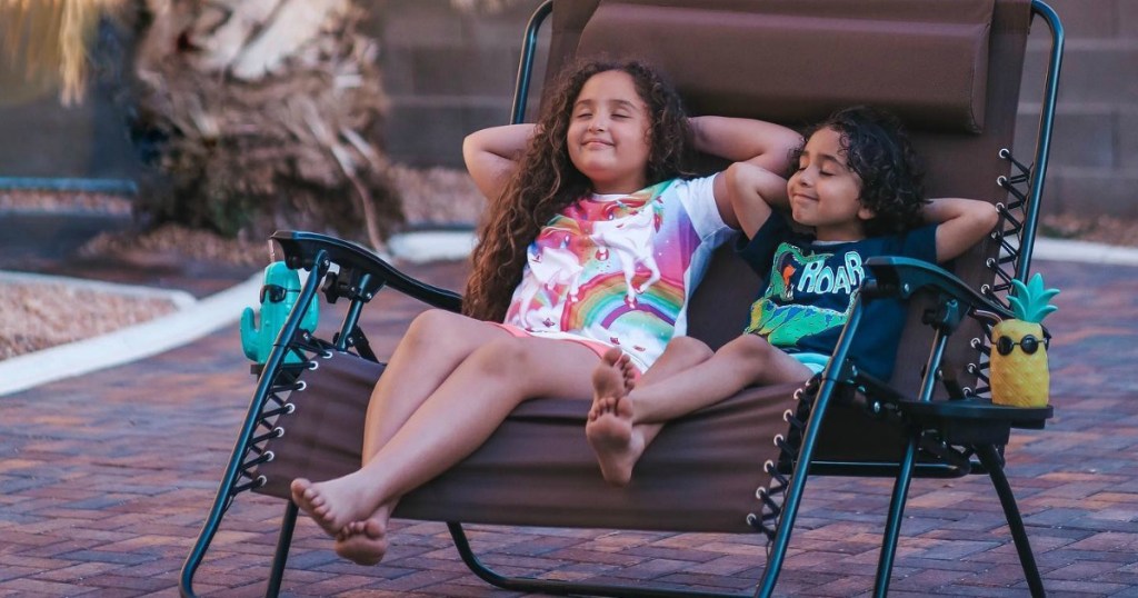 two girls sitting in outdoor lounger 